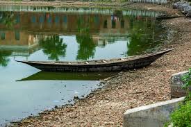 Wooden boats reflecting on still water